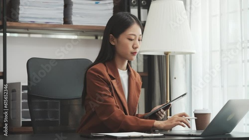 Young chinese business woman doing bookkeeping analyst audit working papers, public offering, cash budget, accrued dividend, note payable, actual cost, aging schedule, intangible fixed asset