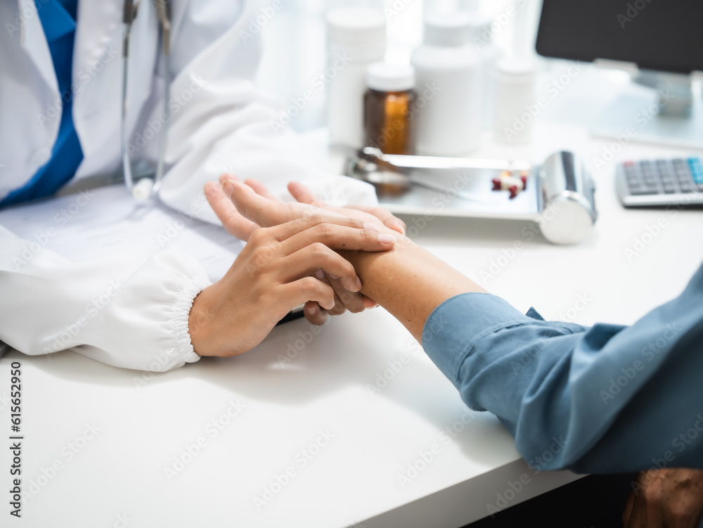 Mature chinese woman in consultation with a doctor with abdominal pain. depression. Mature chinese woman in consultation with a doctor with abdominal pain. depression.