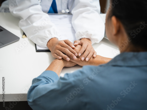 Mature chinese woman in consultation with a doctor with abdominal pain. depression. © makibestphoto