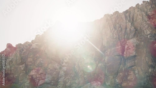 Orange rocks with sun flaring into camera at cape point national park
