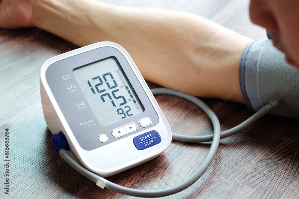 Man check blood pressure monitor and heart rate monitor with digital pressure gauge. Health care and Medical concept Man check blood pressure monitor and heart rate monitor with digital pressure gauge. Health care and Medical concept