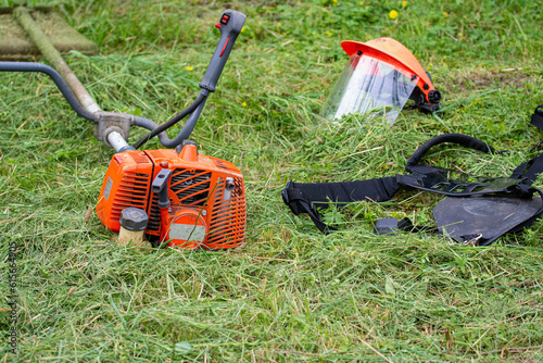 Man cutting grass using gasoline brush cutter
