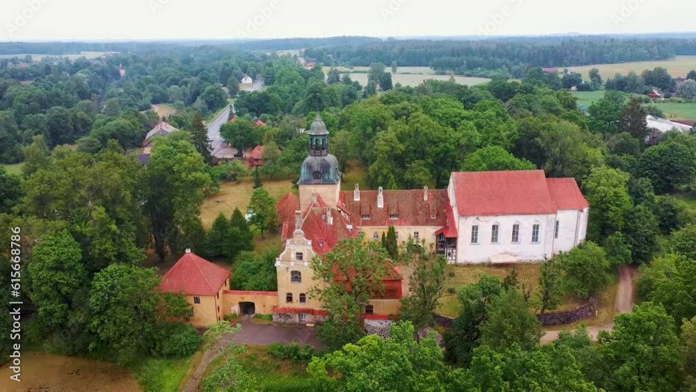 Lielstraupe Medieval Castle in the Village of Straupe in Vidzeme, in Northern Latvia. Aerial Dron Shot Lielstraupe Castle United in One Corps With the Church Surrounded by a Park With Pond. Rainy Day Lielstraupe Medieval Castle in the Village of Straupe in Vidzeme, in Northern Latvia. Aerial Dron Shot Lielstraupe Castle United in One Corps With the Church Surrounded by a Park With Pond. Rainy Day