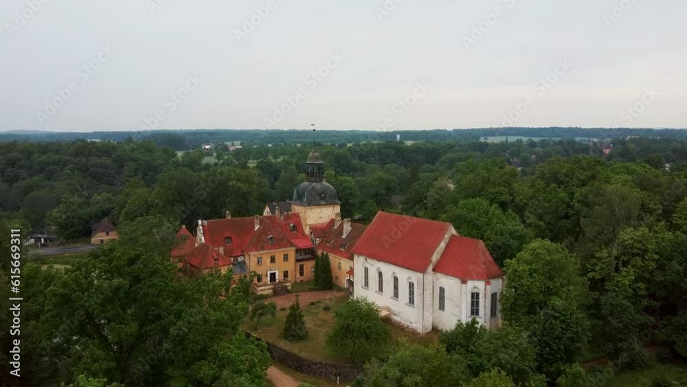 Lielstraupe Medieval Castle in the Village of Straupe in Vidzeme, in Northern Latvia. Aerial Dron Shot Lielstraupe Castle United in One Corps With the Church Surrounded by a Park With Pond. Rainy Day Lielstraupe Medieval Castle in the Village of Straupe in Vidzeme, in Northern Latvia. Aerial Dron Shot Lielstraupe Castle United in One Corps With the Church Surrounded by a Park With Pond. Rainy Day