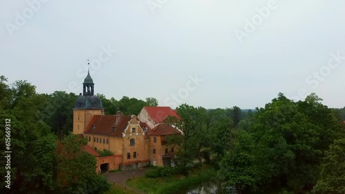 Lielstraupe Medieval Castle in the Village of Straupe in Vidzeme, in Northern Latvia. Aerial Dron Shot Lielstraupe Castle United in One Corps With the Church Surrounded by a Park With Pond. Rainy Day photo