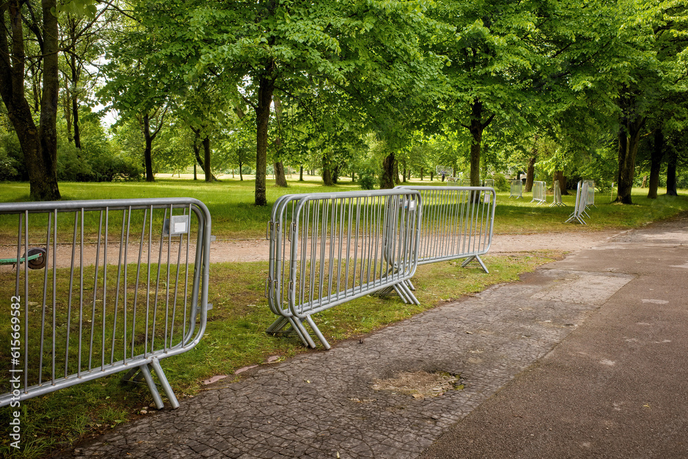 Temporary fencing. Security. Mass event. A large crowd of people. Portable sectional fence. Steel mobile fence on the street. Police fence. Temporary fencing. Security. Mass event. A large crowd of people. Portable sectional fence. Steel mobile fence on the street. Police fence.