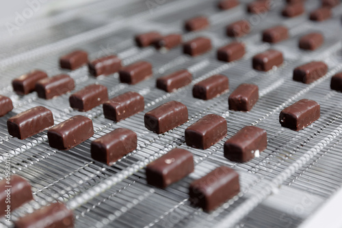Chocolate sweets candy on industry conveyor. Modern production line of food factory