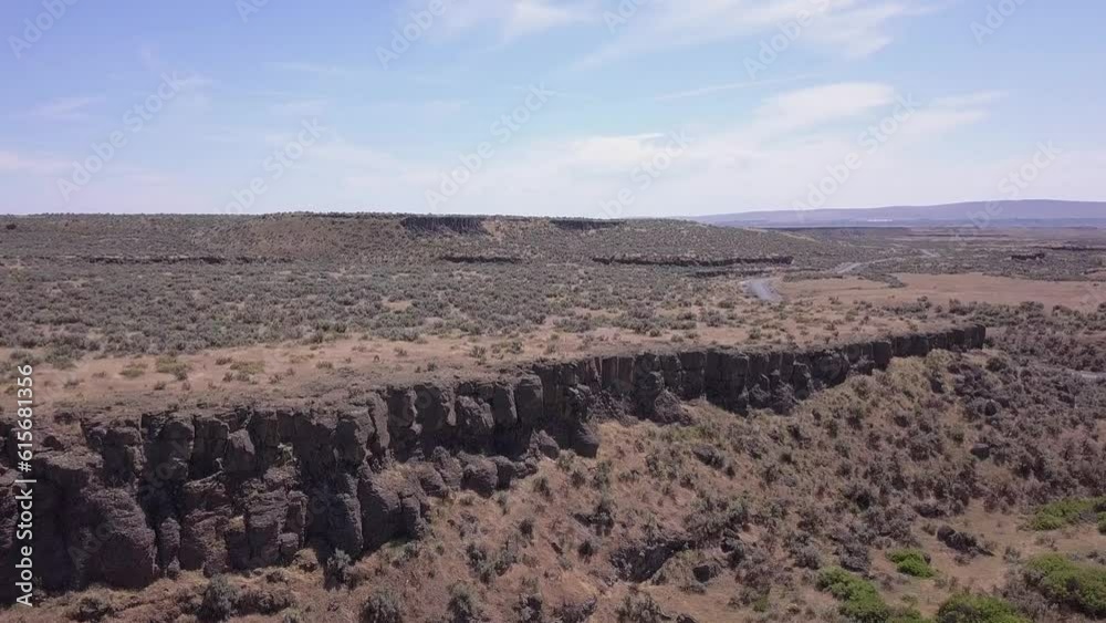 Aerial descends to low rock bluffs in Channeled Scablands, central WA