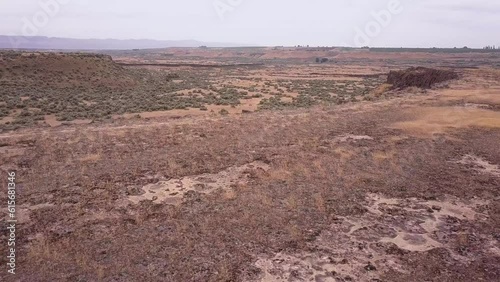 Flyover Scablands sagebrush plateau and over tall rock column cliffs photo