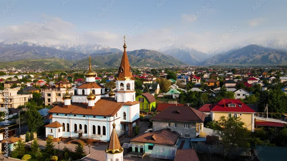 Orthodox church at sunrise agains the mountains in Almaty Orthodox church at sunrise agains the mountains in Almaty