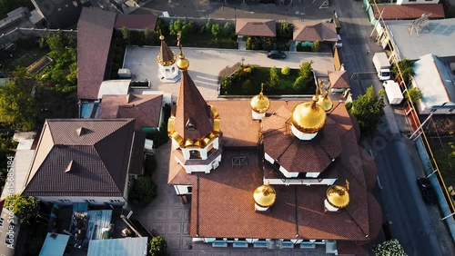 Orthodox church at sunrise agains the mountains in Almaty photo