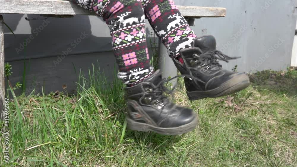 child's feet on the bench,slowly move your legs while sitting on a bench Stock ビデオ Adobe Stock