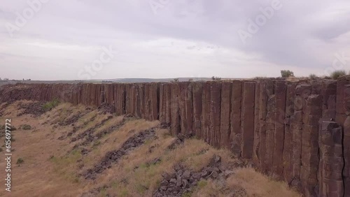 Quick flight along cliff face of volcanic rock columns in WA Scablands photo