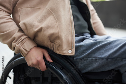 Close-up of young man with disability sitting in wheelchair outdoors