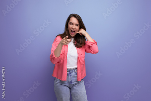 optimist young lady in shirt and jeans on studio isolated background