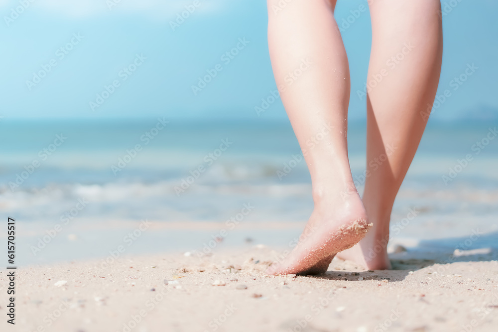 Close up woman legs walking on tropical beach with smooth wave abstract background. Travel vacation and freedom feel good concept. Vintage tone color style. Close up woman legs walking on tropical beach with smooth wave abstract background. Travel vacation and freedom feel good concept. Vintage tone color style.