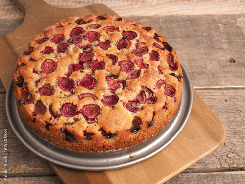 Tasty organic cherry cake on a rustic wooden kitchen table