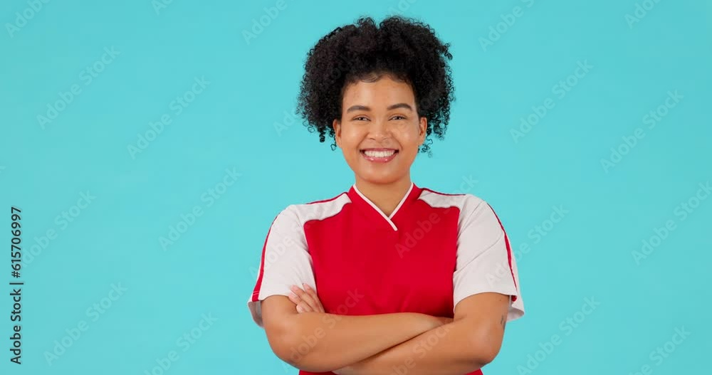 Sports, soccer and woman athlete smile and happy after training or exercise isolated in a studio blue background. Confident, fitness and portrait of a young person or football player ready for match