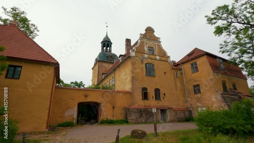 Lielstraupe Medieval Castle in the Village of Straupe in Vidzeme, in Northern Latvia. 4K Shot Lielstraupe Castle United in One Corps With the Church Surrounded by a Park With Pond. Rainy Day photo