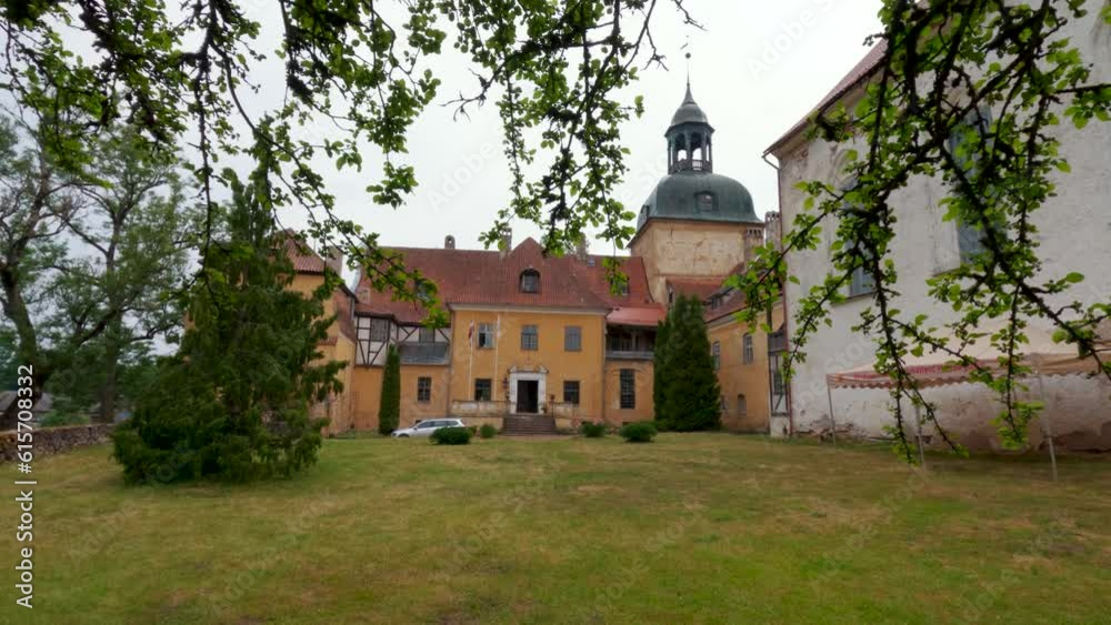 Lielstraupe Medieval Castle in the Village of Straupe in Vidzeme, in Northern Latvia. 4K Shot Lielstraupe Castle United in One Corps With the Church Surrounded by a Park With Pond. Rainy Day Lielstraupe Medieval Castle in the Village of Straupe in Vidzeme, in Northern Latvia. 4K Shot Lielstraupe Castle United in One Corps With the Church Surrounded by a Park With Pond. Rainy Day