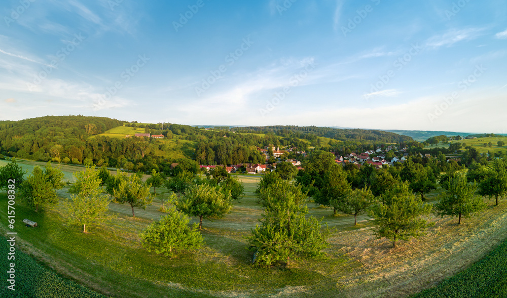 Panorama on valley with meadows, fields, forest and farms against a cloudy sky Panorama on valley with meadows, fields, forest and farms against a cloudy sky