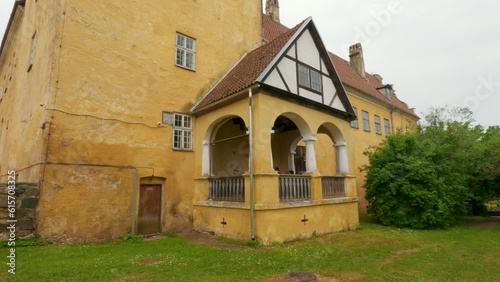 Lielstraupe Medieval Castle in the Village of Straupe in Vidzeme, in Northern Latvia. 4K Shot Lielstraupe Castle United in One Corps With the Church Surrounded by a Park With Pond. Rainy Day photo