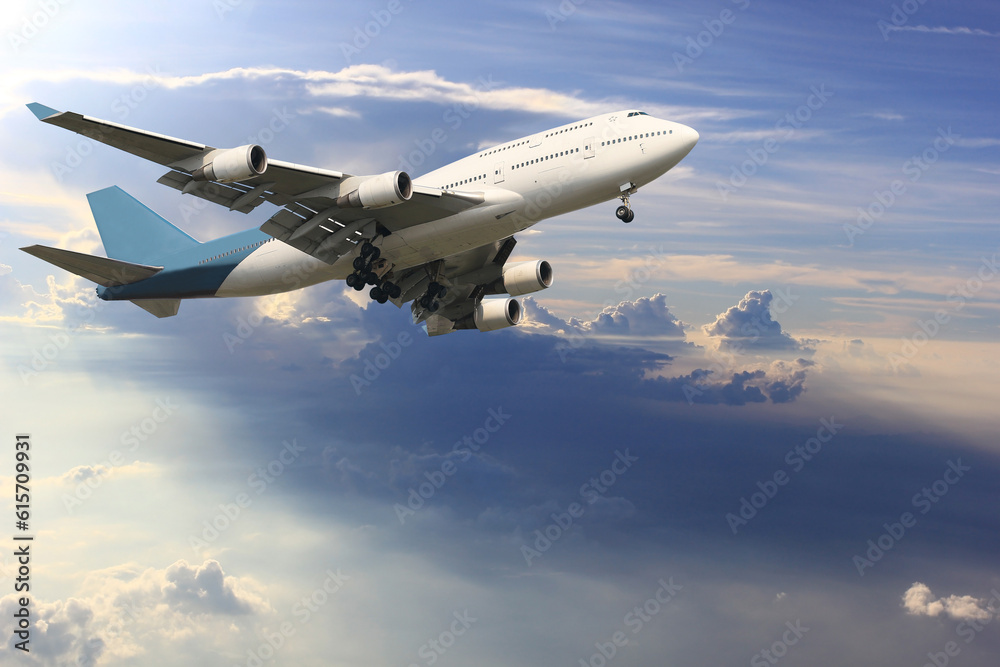 Fototapeta premium Airplane is flying above the clouds on beautiful sky background,Holidays and business concept