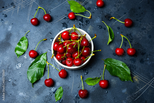 Fresh red cherry, scattered cherry concept on black background, top view.
