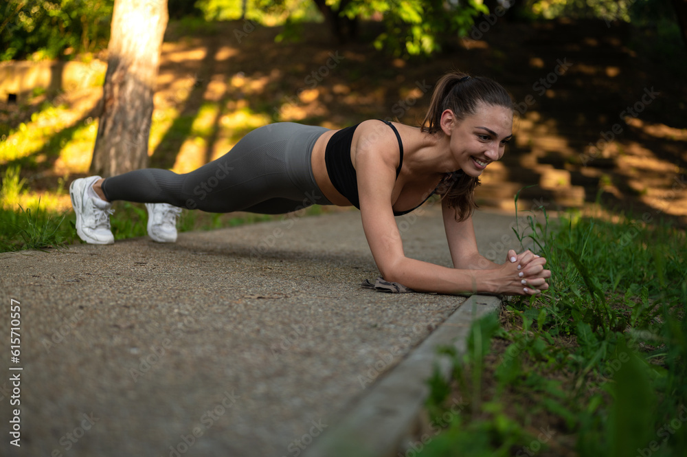 Sport fit woman doing stretching exercise in the park