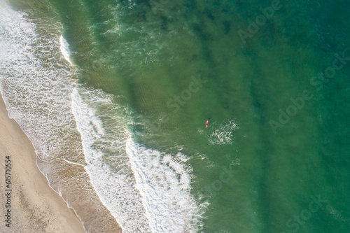 top view with drone of a surfer with a red board