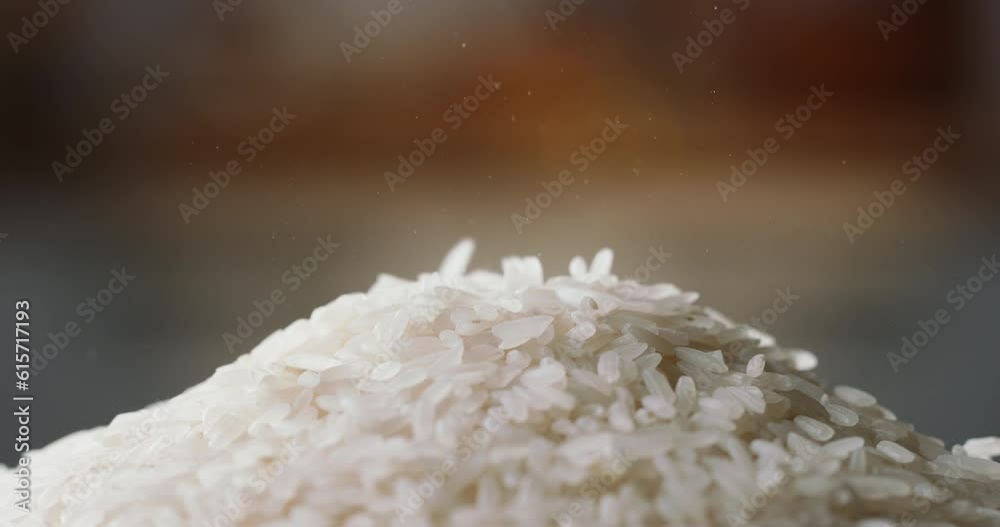 Raw rice piled up side view home kitchen blurred background Asian Chinese Thai Japanese Indian traditional cuisine. Organic vegetarian healthy food nutrition Raw rice piled up side view home kitchen blurred background Asian Chinese Thai Japanese Indian traditional cuisine. Organic vegetarian healthy food nutrition