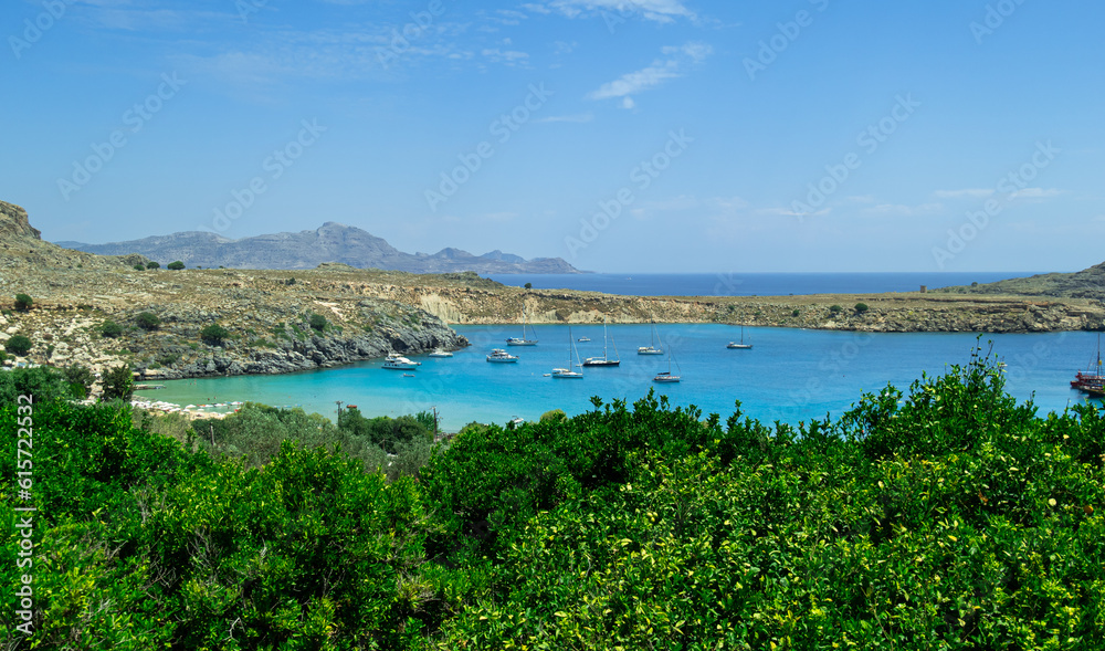 Panoramic view of the beautiful secluded bay and beach at Lindos town on the island of Rhodes, Greece