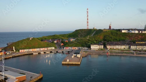 Aerial footage of the island of Heligoland with a view of the Hummerbuden and southern harbor Unterland in beautiful summer morning, Schleswig-Holstein, Germany. photo