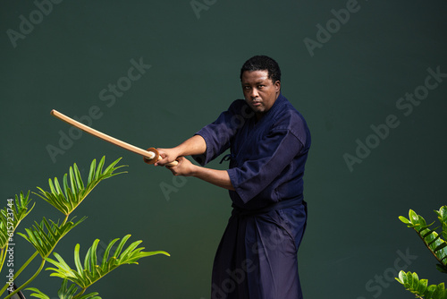 Handsome black martial artist man with martial arts costume of kendo photo