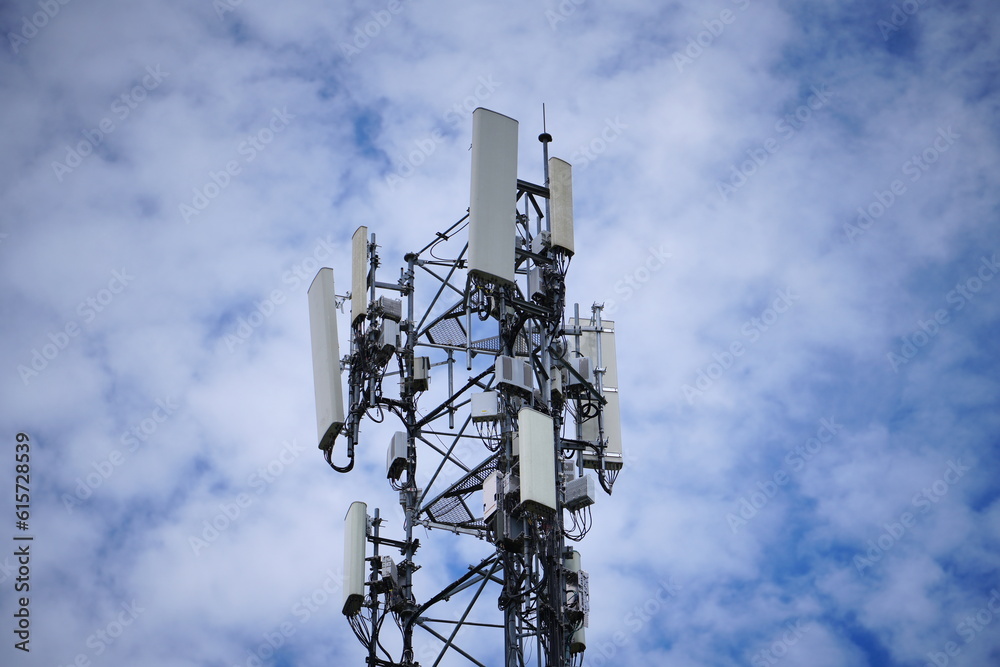 Telecommunication tower of 4G and 5G cellular. Macro Base Station. 5G radio network telecommunication equipment with radio modules and smart antennas mounted on a metal against cloulds sky background. Telecommunication tower of 4G and 5G cellular. Macro Base Station. 5G radio network telecommunication equipment with radio modules and smart antennas mounted on a metal against cloulds sky background.