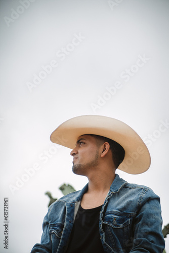 Cowboy under the vast sky, surrounded by cacti, working on a farm