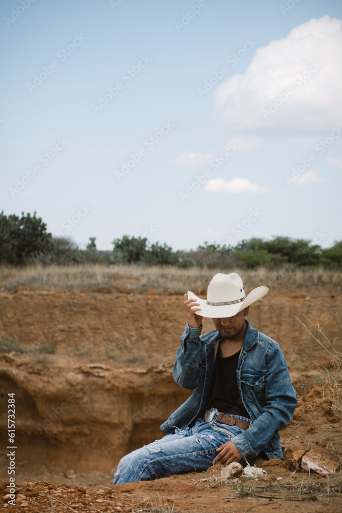 Cowboy under the vast sky, surrounded by cacti, working on a farm Cowboy under the vast sky, surrounded by cacti, working on a farm