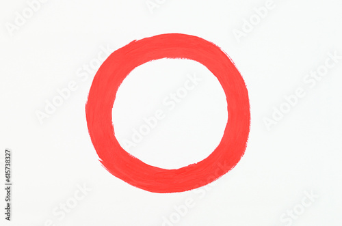 Red round paint stroke on a white background