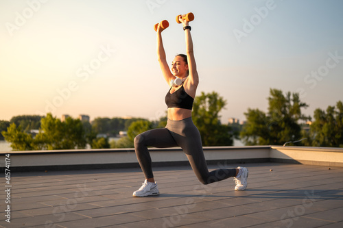 Fotografie, Tablou Sport girl doing  exercise on sunny summer day, on rooftop
