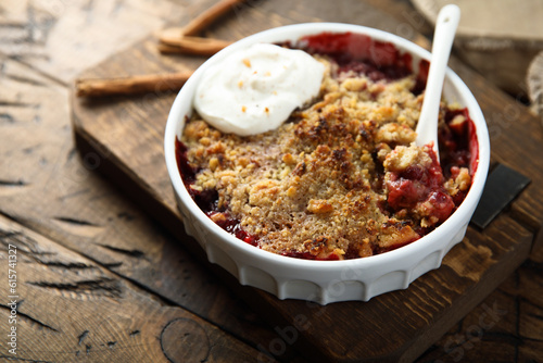 Traditional homemade berry crumble with cream