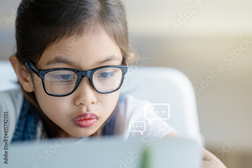 A girl is using a laptop computer for education and learning online.