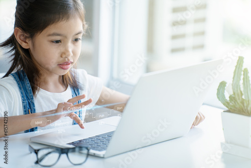 A girl is using a laptop computer for education and learning online.