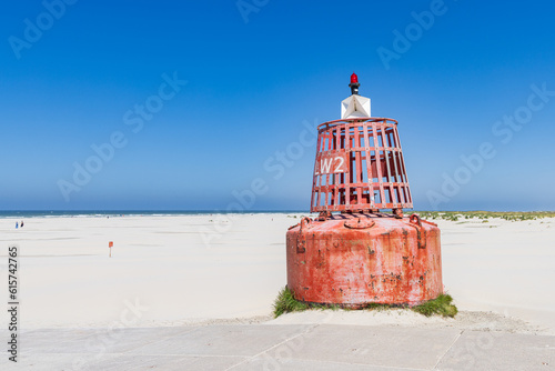 Red buoy at Formerum beach at Wadden island Terschelling in Friesland province in The Netherlands photo