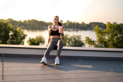 Young athleete sport girl on break after workout done on the rooftop, on sunny summer day © Nemanja