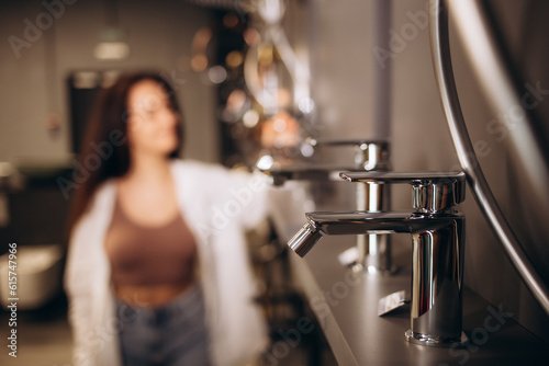 brunette woman looking faucets at plumbing store