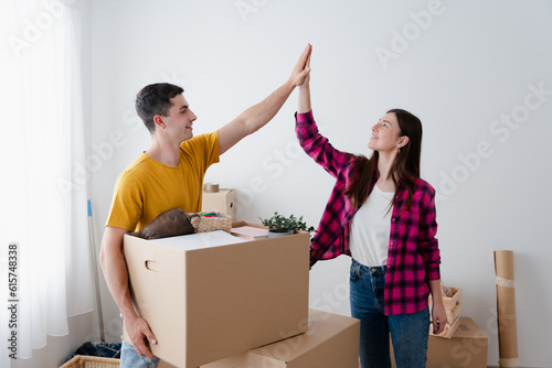 Young couple giving high five at home