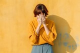 Shameful young woman covers her face with her hands. Ai generated.