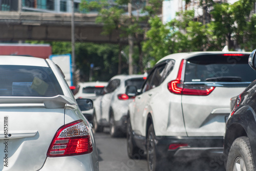 Smoke from city traffic and car emissions pollutes the air. lowering carbon dioxide emissions from vehicle combustion and global warming pollution.