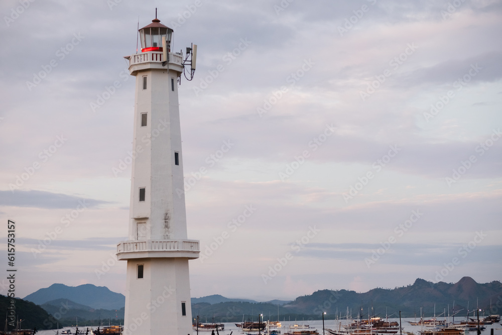 A beautiful white lighthouse against the sky in the port town of Labuan Bajo, Indonesia.