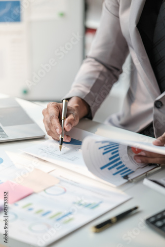 Close up young man with calculator counting making notes at home, hand is writing in a notebook. Savings finances concept